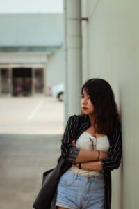 Woman Standing Beside White Wall