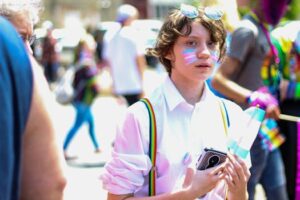 Boy Holding Smartphone and Flaglet