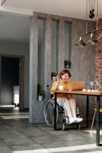 Woman in Orange Tank Top Sitting on Black Wheelchair