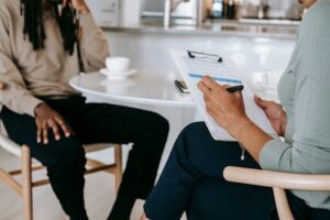 Crop faceless multiethnic interviewer and job seeker going through interview